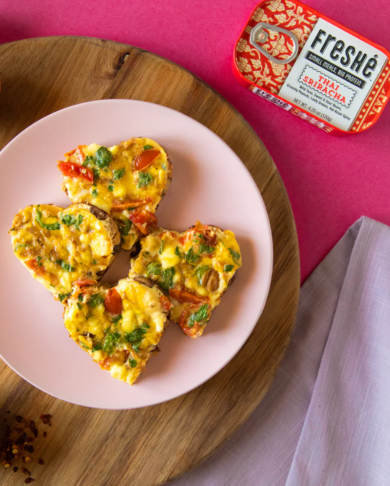 Heart-shaped Thai Sriracha tuna frittata bites on a pink plate beside a Freshé tin